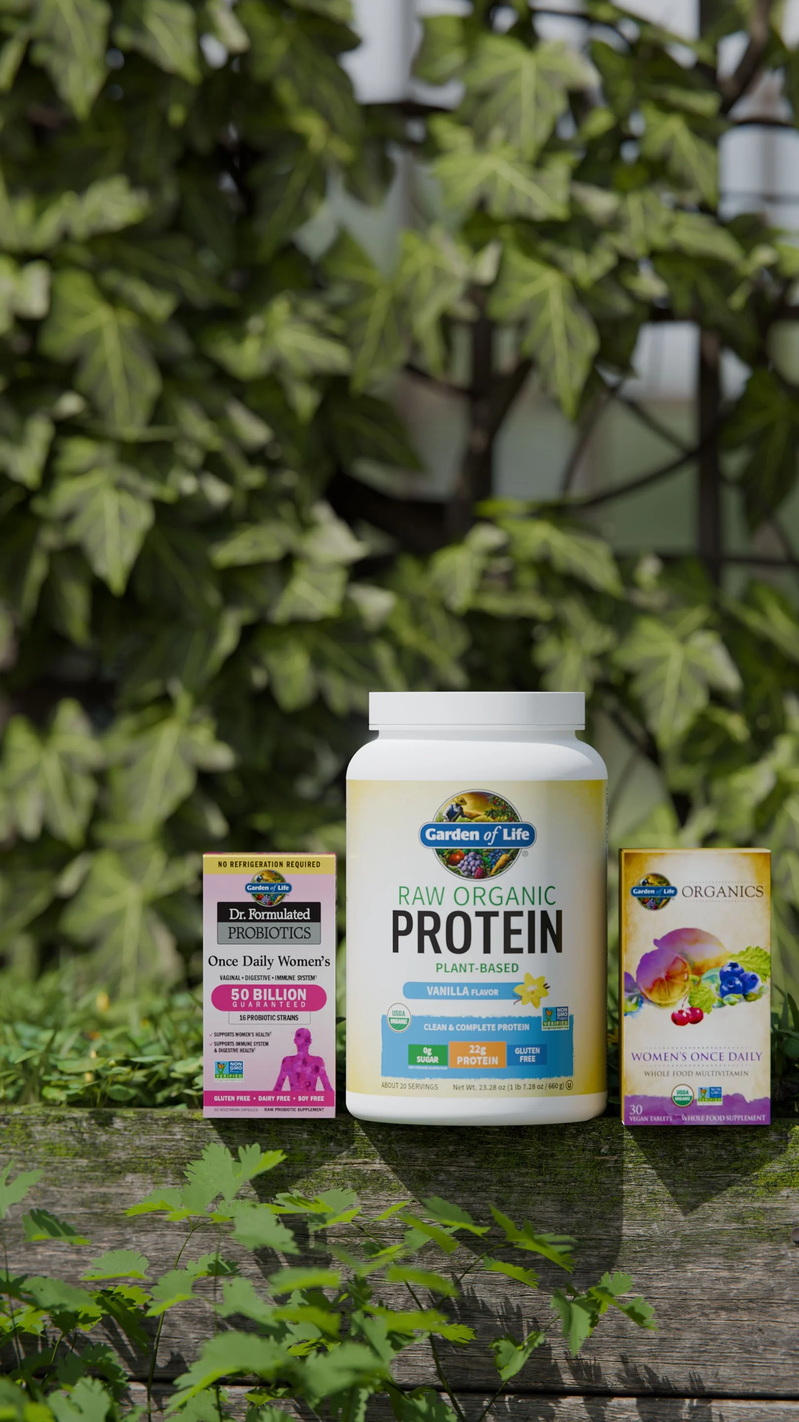 Supplements on a wooden surface with green leafy background, including Garden of Life Raw Organic Plant-Based Protein, Women's Once Daily multivitamin, and Dr. Formulated Probiotics for Women's health.