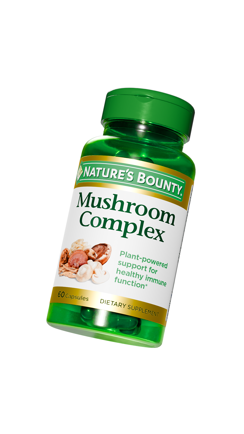 Bottle of Nature's Bounty Mushroom Complex dietary supplement capsules with a green lid and label, featuring an image of various mushrooms.