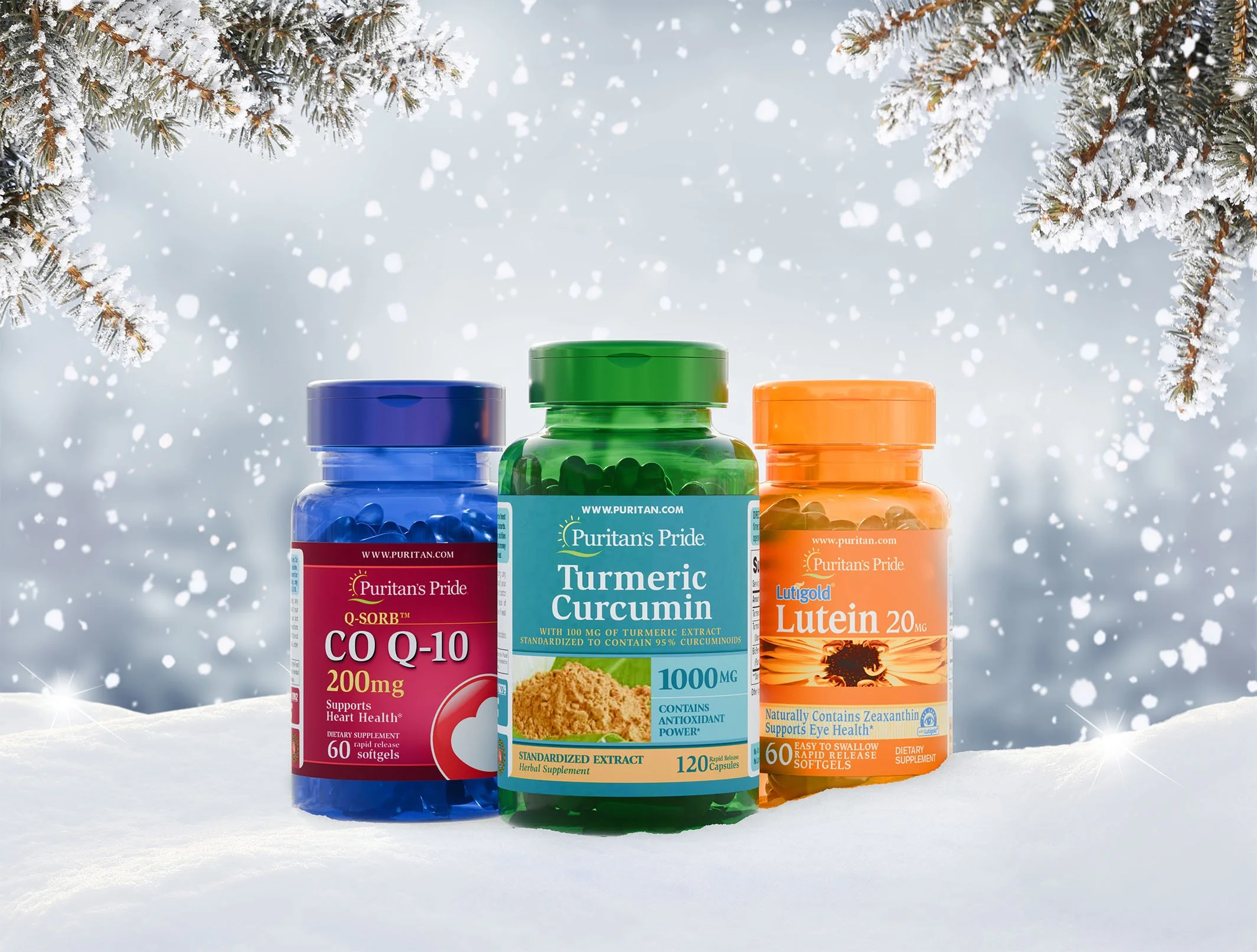 Three bottles of dietary supplements on snow with snow-covered tree branches overhead. The bottles contain CoQ10, turmeric curcumin, and lutein supplements.