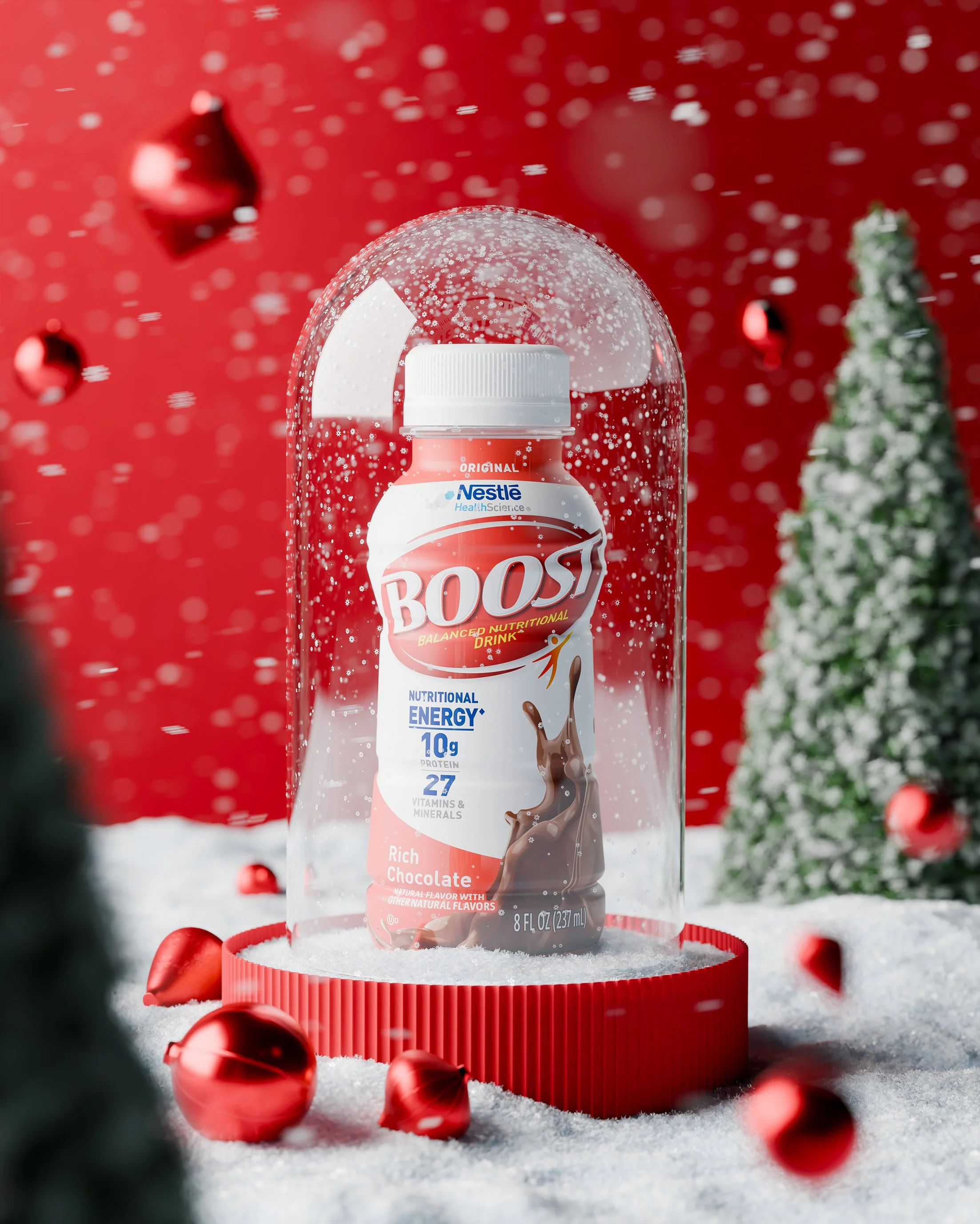 A bottle of Boost chocolate flavored nutritional energy drink, inside a clear dome on a red base, surrounded by snow, small Christmas trees, and red ornaments against a red background.