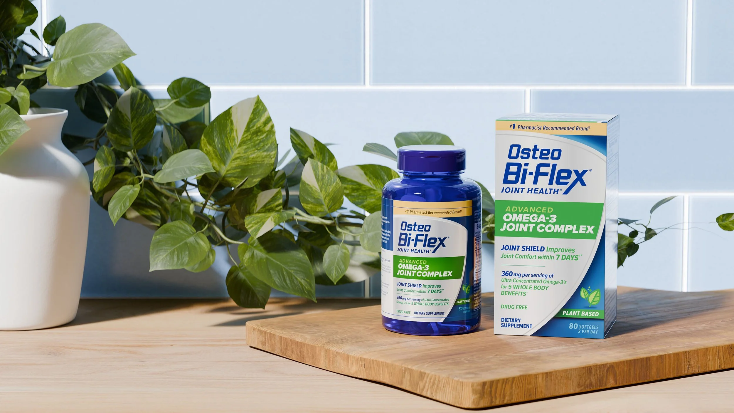 A bottle and box of Osteo Bi-Flex joint health supplement with a green leafy plant and white vase in the background.