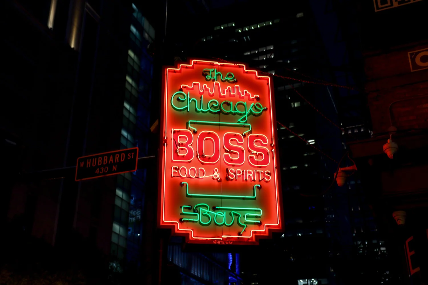 The Boss Bar neon sign at night on W Hubbard St