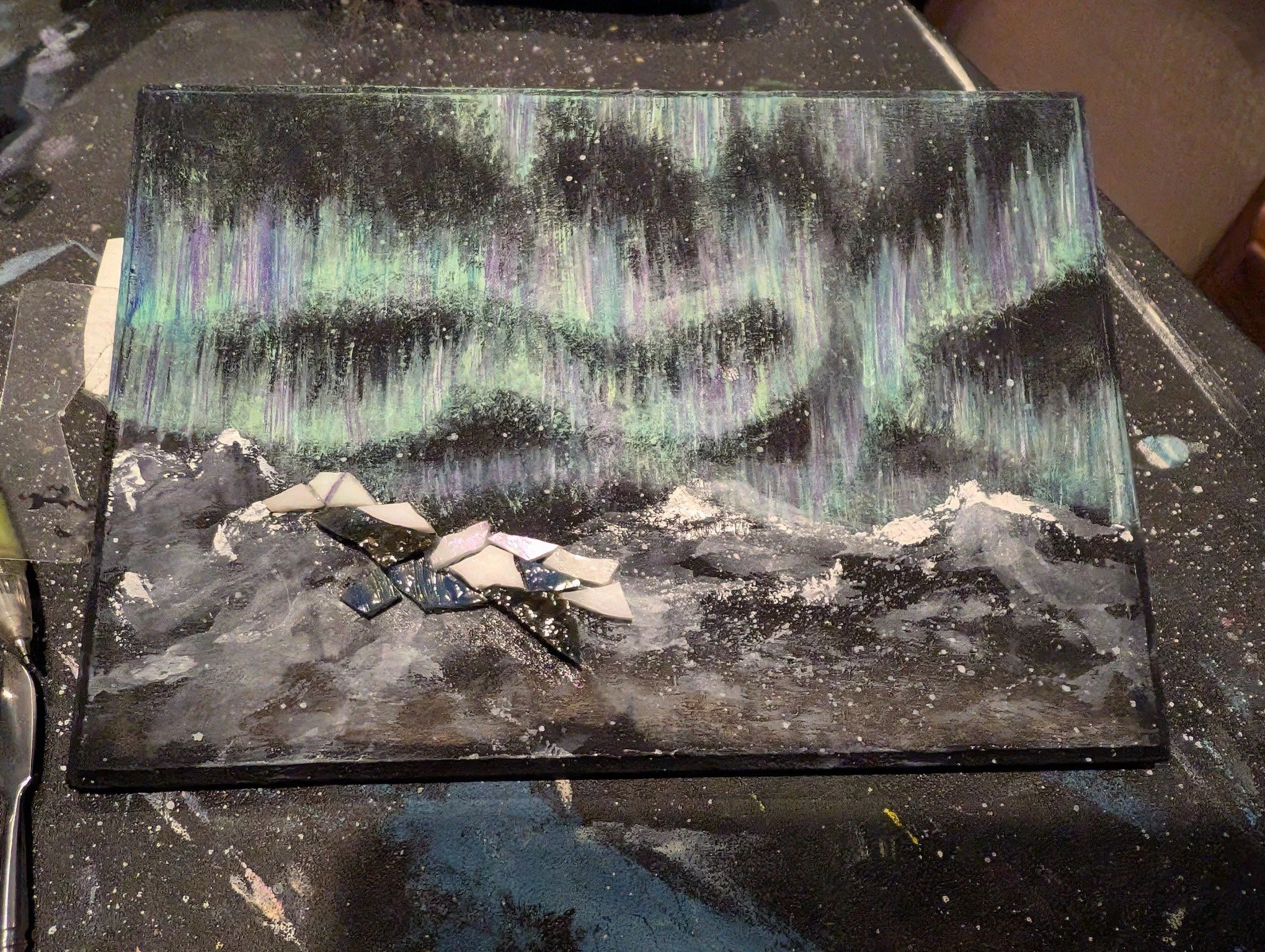 Incorporating glass into paintings is a fun challenge. I wasn't exactly sure how these mountains would turn out with the painted auroras, but I love it! I also used some iridescent pieces for some of the white pieces, trying to capture the way the li