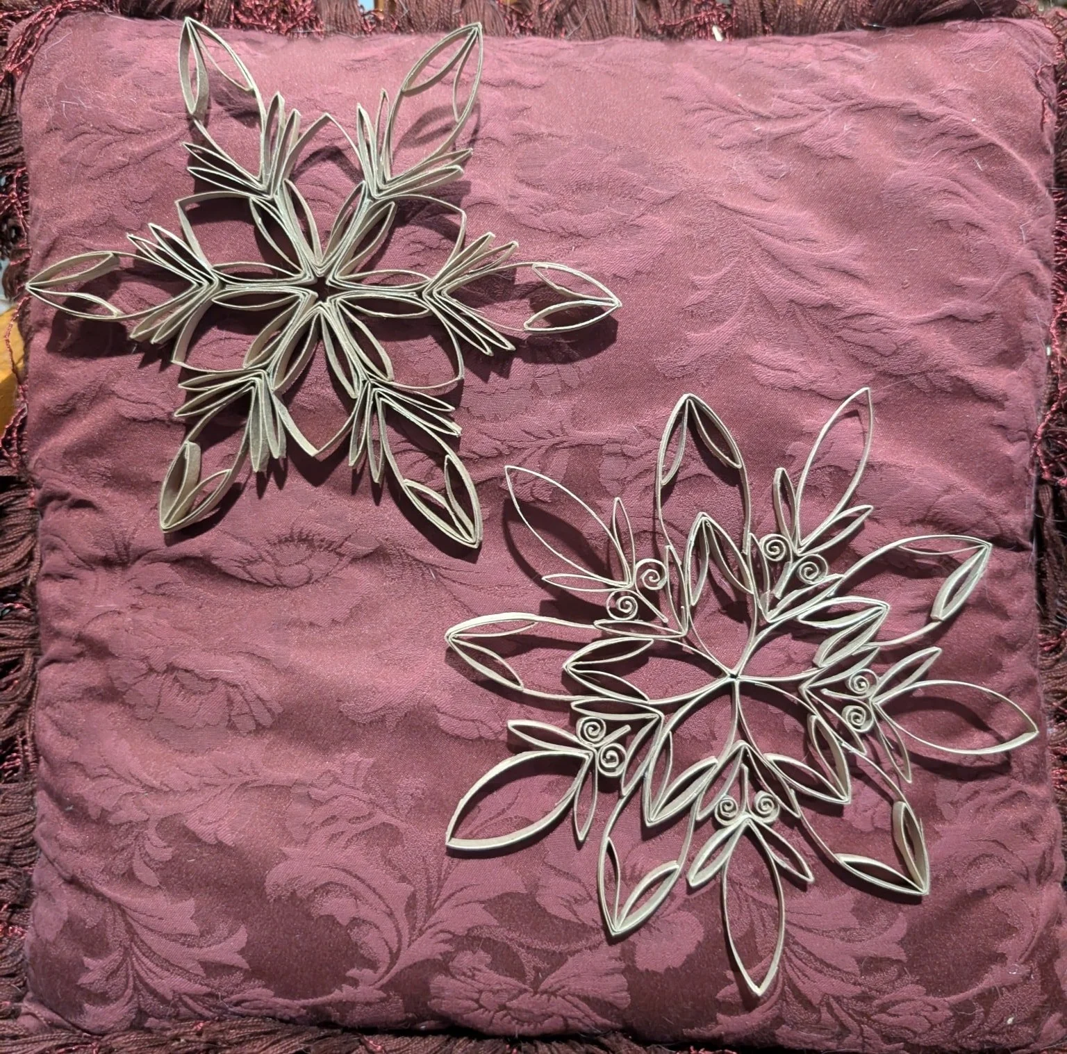 I've already adjusted the first snowflake I've posted and finished a second. Please enjoy a photo of them both together. I plan to make at least one more to hang with my garland behind my desk. Perhaps a few smaller ones to make a whole new garland o