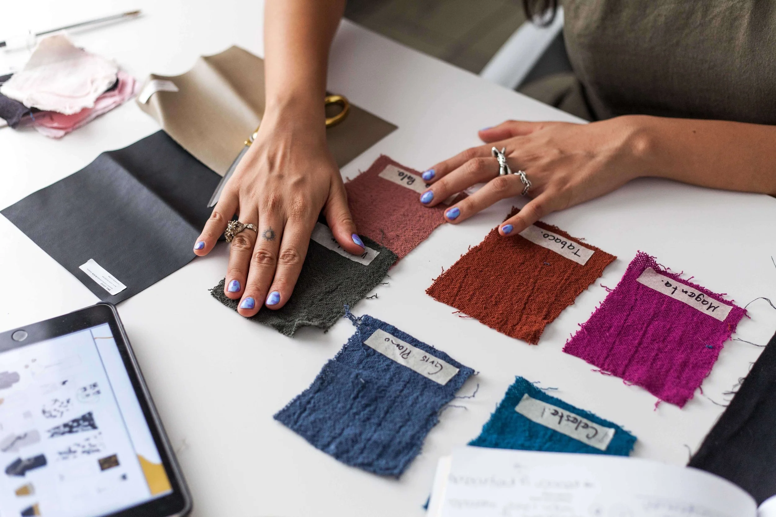woman choosing fabrics and colours before sewing