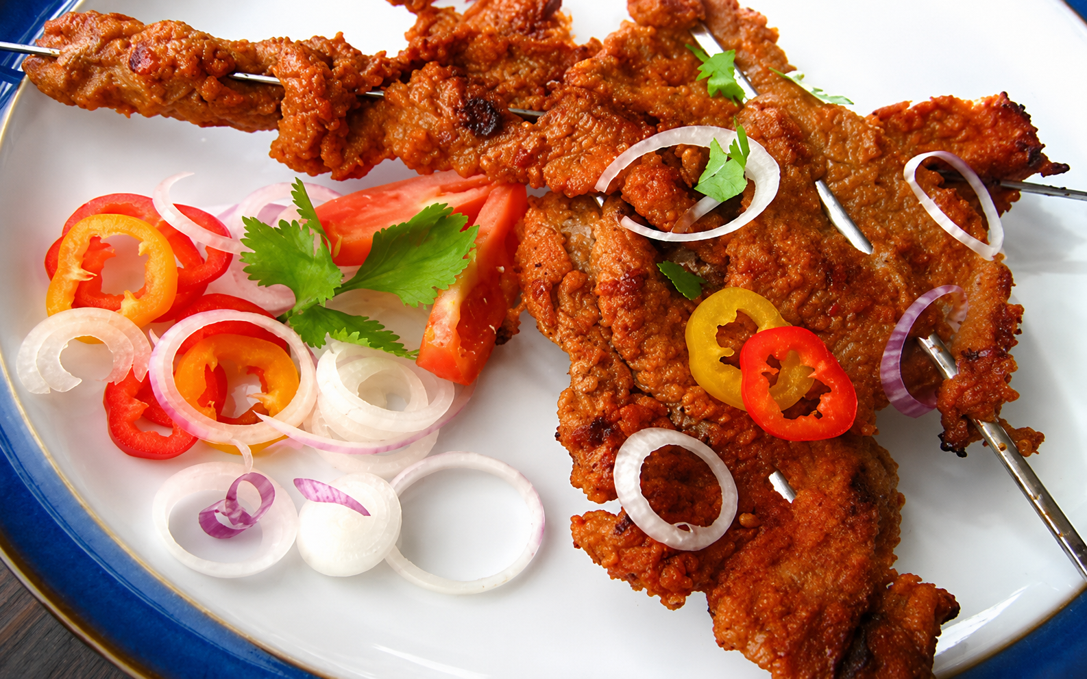 Thin slices of Nigerian kilishi coated in spices and grilled.