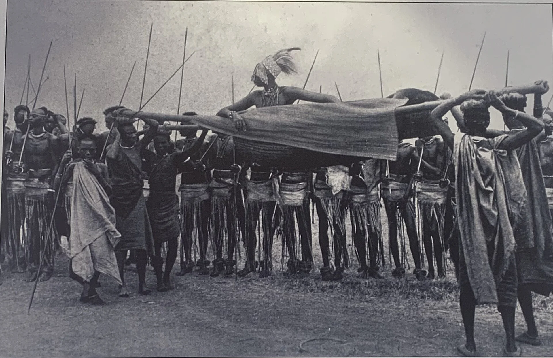 Historical image of Rwandan King Yuhi V Musinga being carried in an open royal litter in 1907
