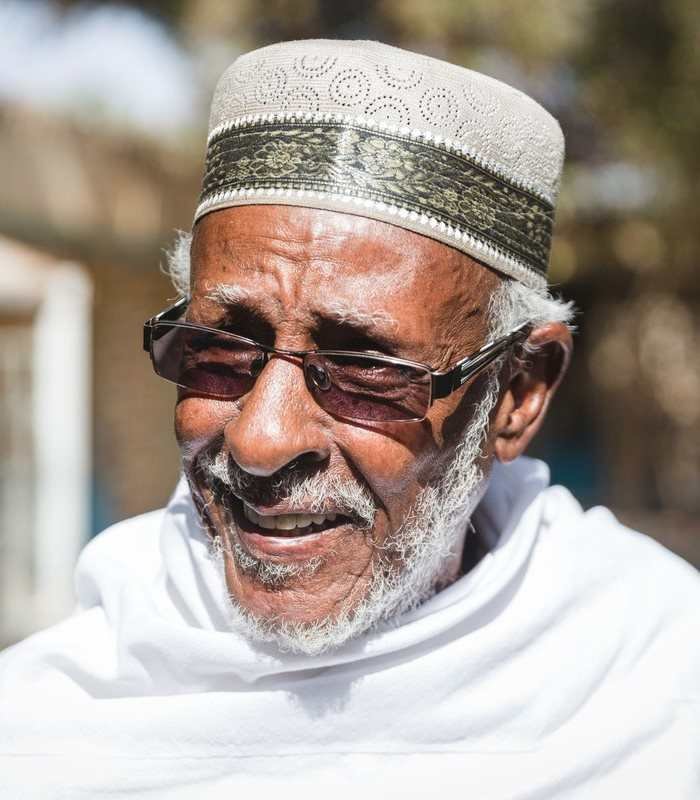 Portrait of Somali poet Maxamed Ibraahin Warsame Hadrawi wearing a patterned kufi