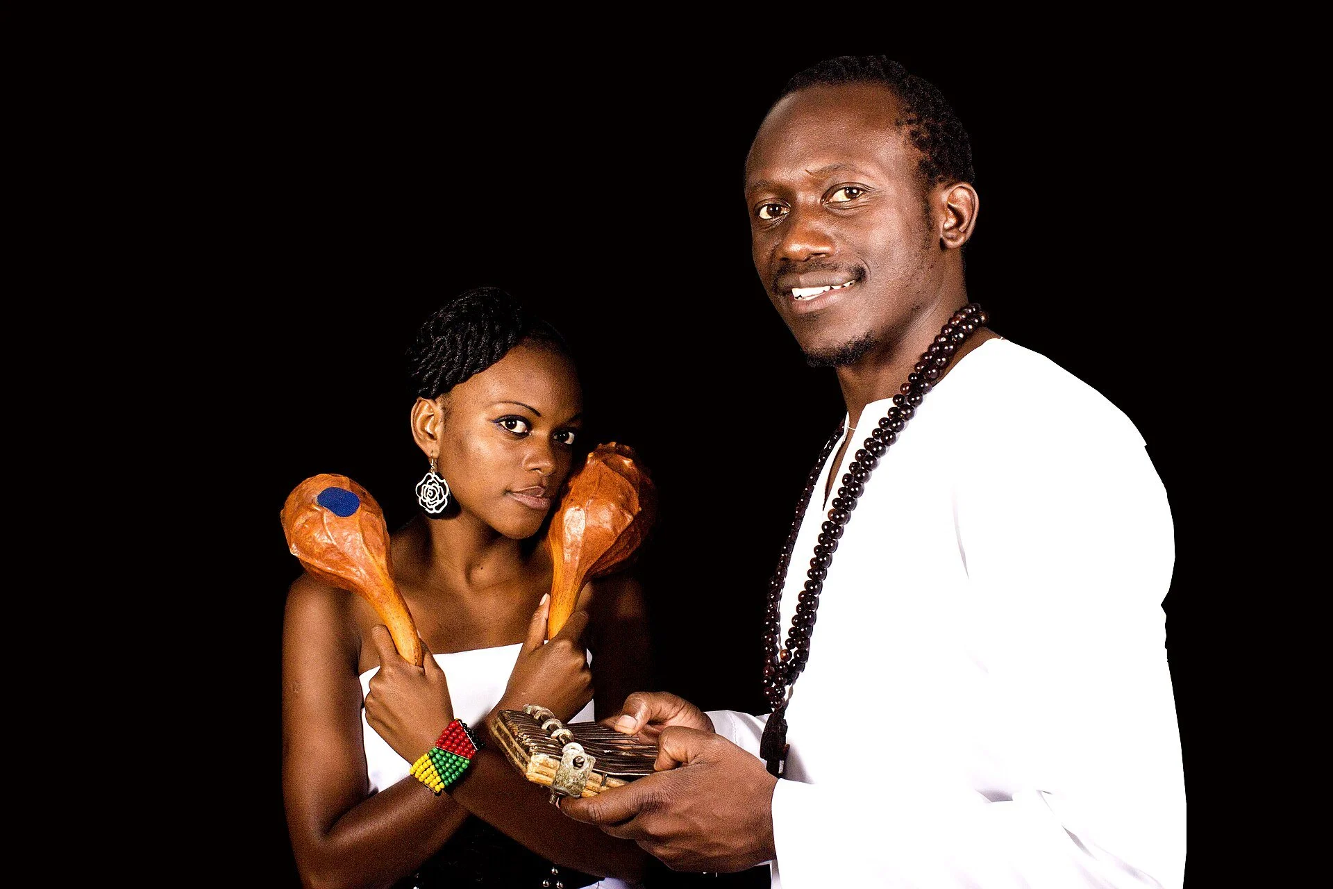 Zimbabwean musicians holding a traditional mbira and two hosho gourd rattles
