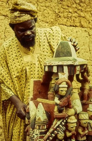 Duro Ladipo examining a Yoruba Ẹpa sculpture in Erinmope, Ekiti, Nigeria, in 1974.