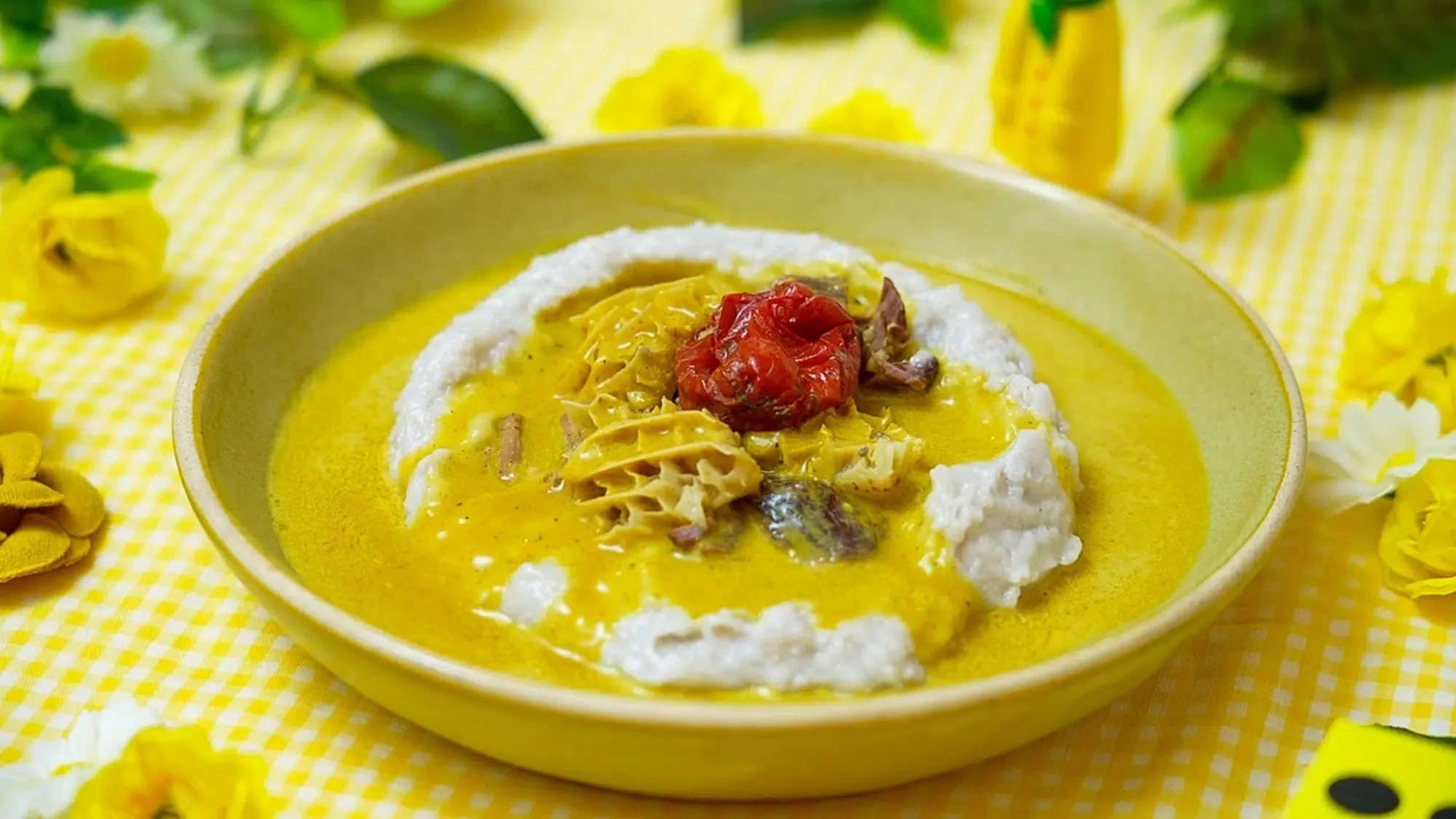 Cameroonian achu served with yellow soup and assorted meat.