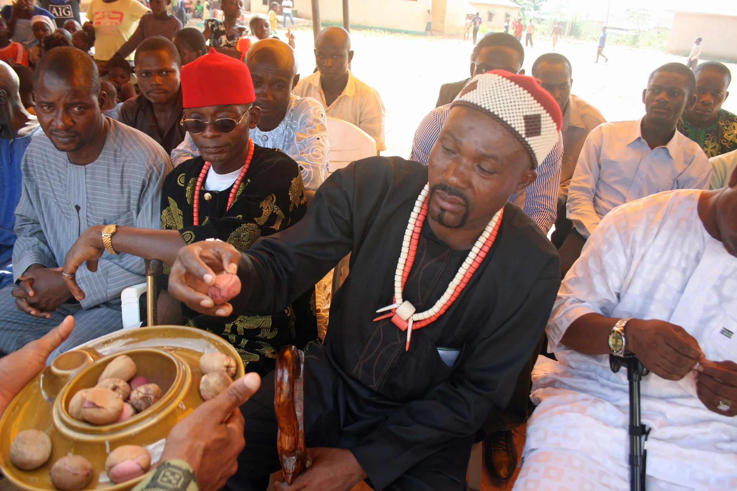 Igbo elders presenting kola nuts during a traditional cultural ceremony.