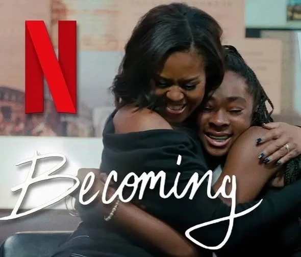 Two women hugging and smiling in an emotional moment, with a large red Netflix logo and the word "Becoming" overlayed.