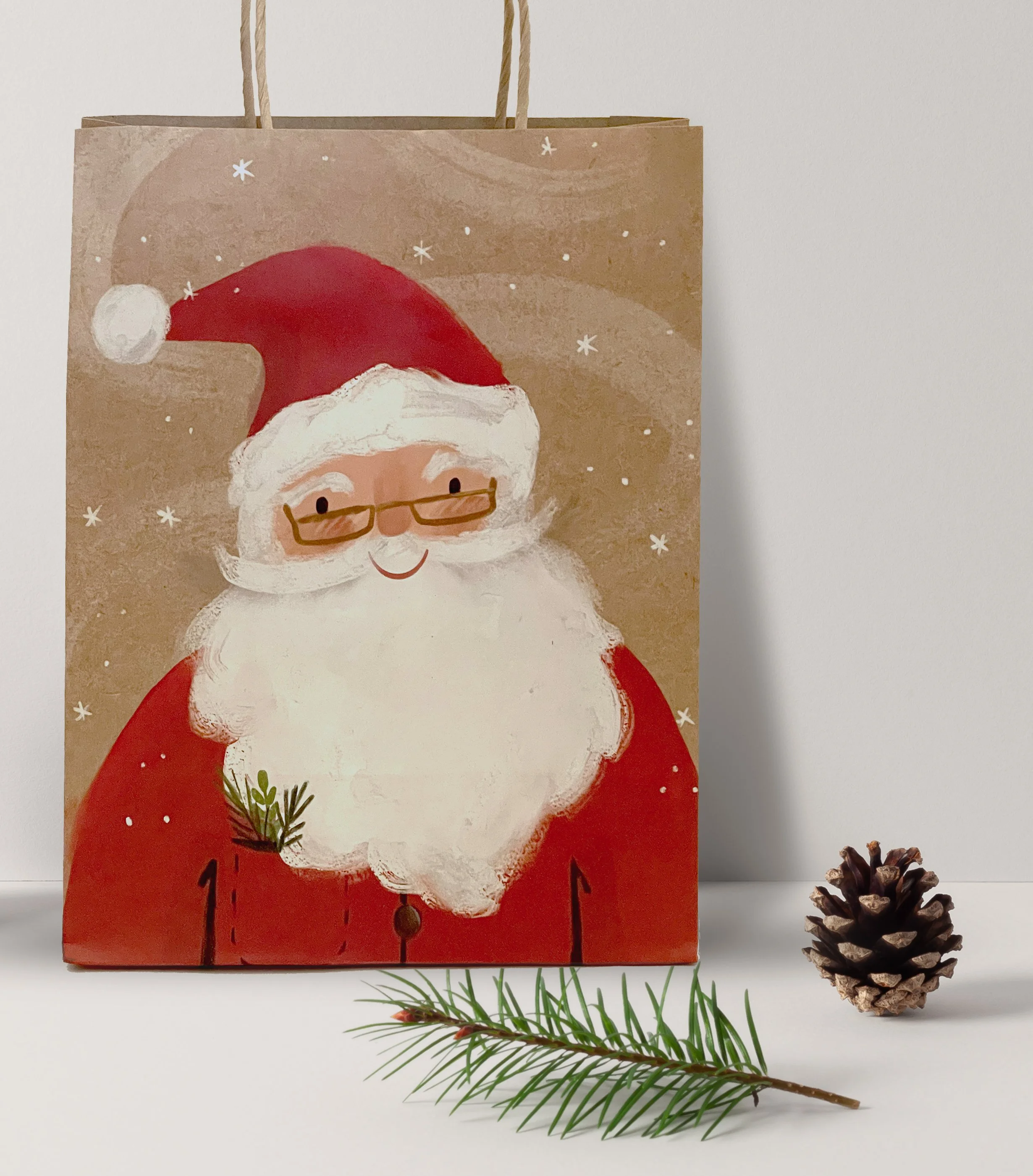 Christmas gift bag with a Santa Claus illustration, a pine cone, and a pine branch
