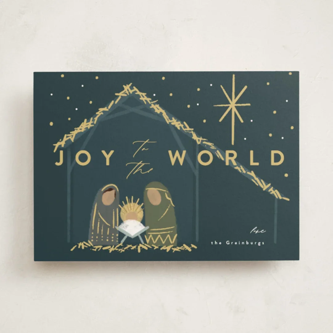 A Christmas card with a nativity scene and the words 'Joy to the World' in gold lettering, featuring stylized figures of Mary, Joseph, and baby Jesus in a manger, with stars above.