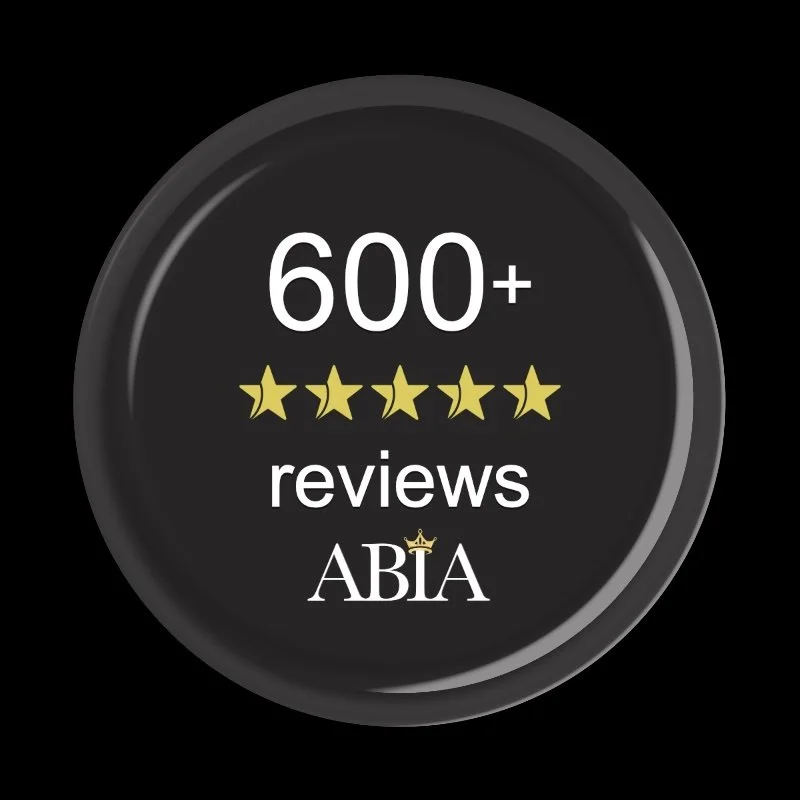 A round badge indicating over 600 reviews with five-star ratings, featuring the ABIA logo with a small crown above the A.