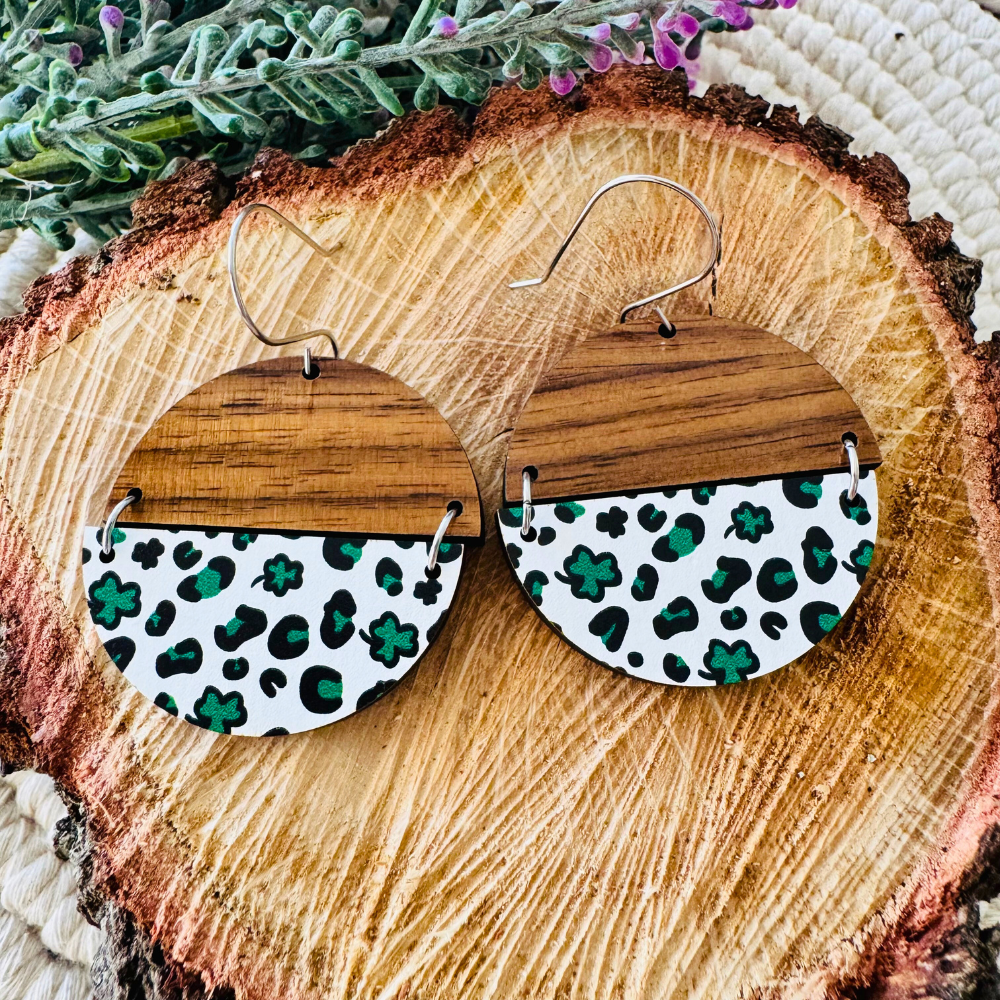 Rustic Luck Earrings displayed on a wood slice with greenery, highlighting their natural charm.