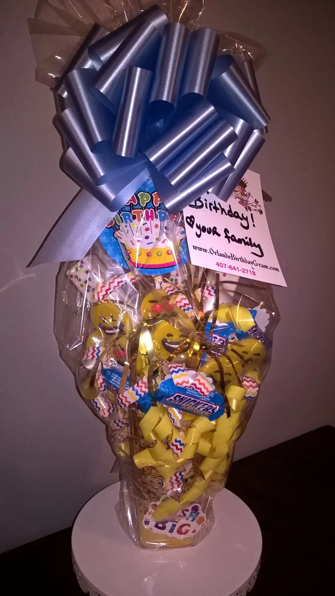 Colorful birthday arrangement with blue and yellow candies, a 