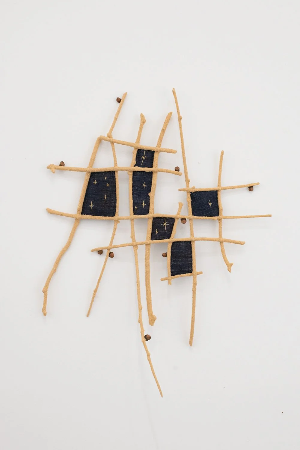 Capucine Bourcart_A CLEAR NIGHT IN NOVEMBER_2025_Branches, gold thread, pinecone scales, sawdust, fabric_33x24.75x4.75 IN.jpg