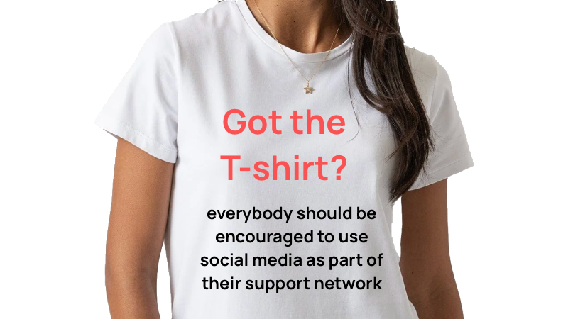 White T-shirt with red and black text promoting social media support, worn by a woman with a gold star necklace and long brown hair.