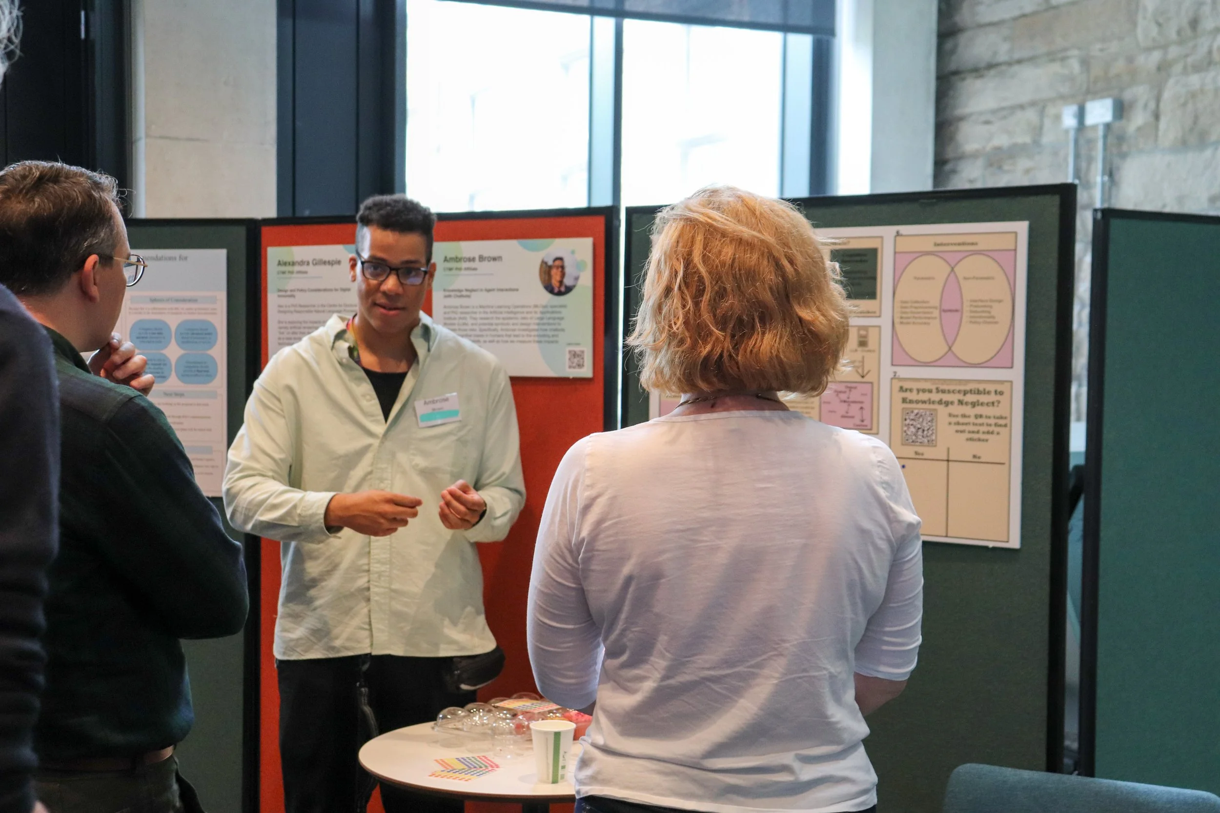 Ambrose Brown discussing their poster presentation