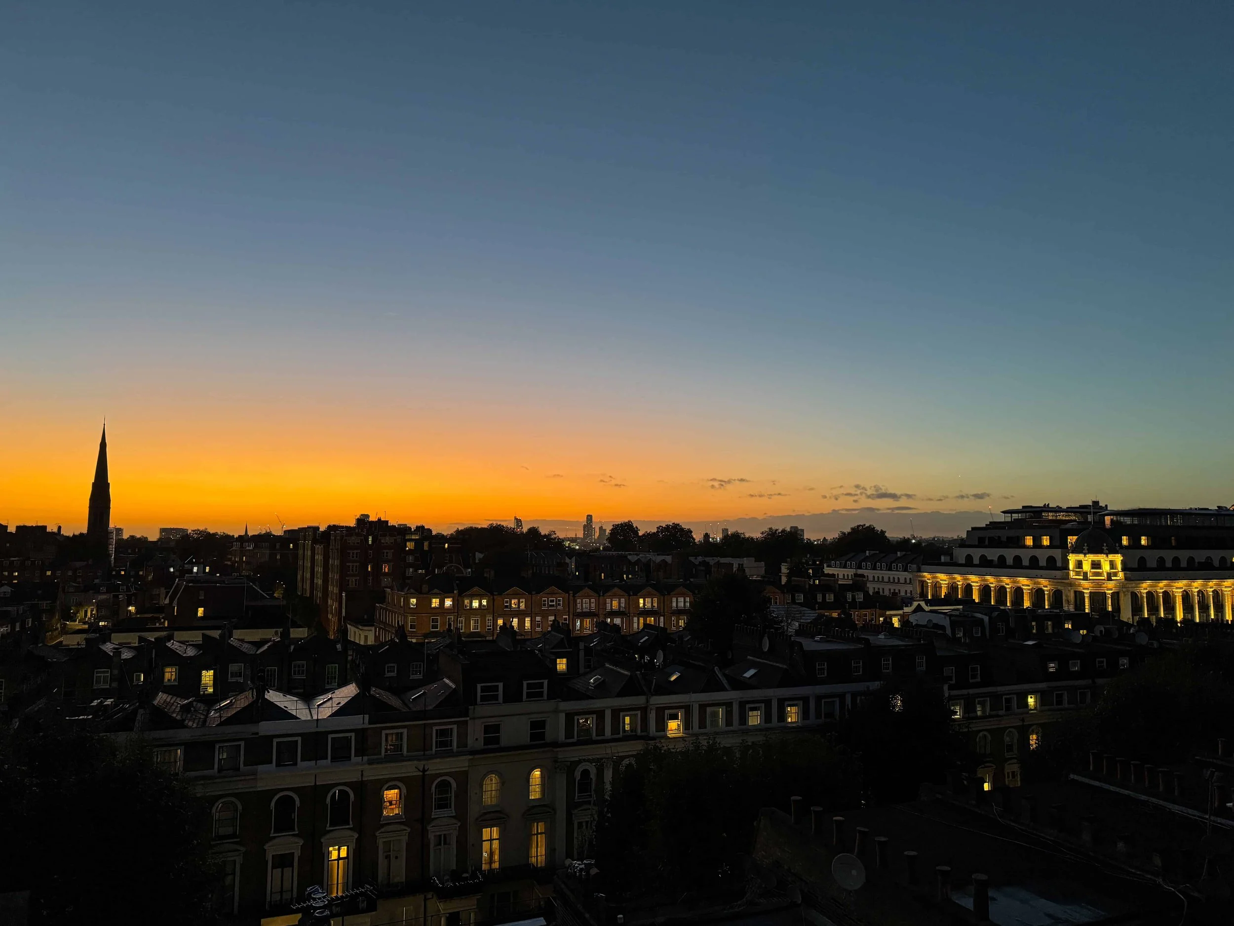 Stunning orange sunset skyline view from budget family accommodation in London, capturing the city's evening beauty."