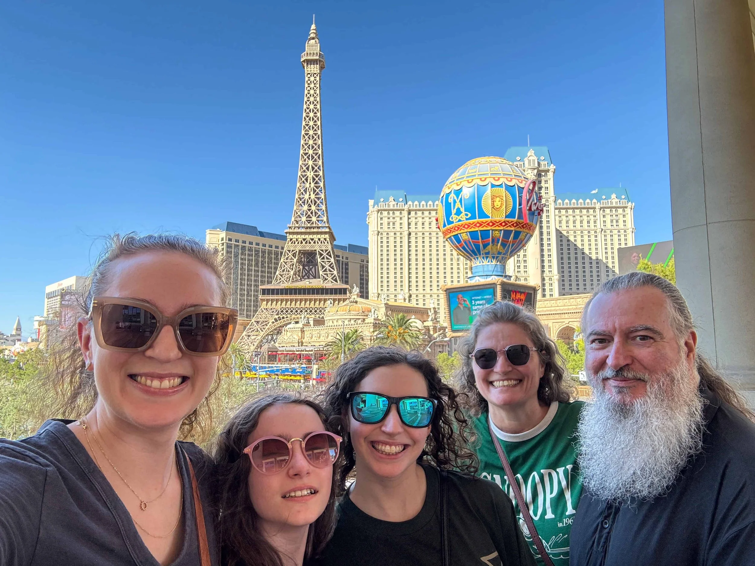 A family selfie near Bellagio Hotel overlooking the Las Vegas strip.