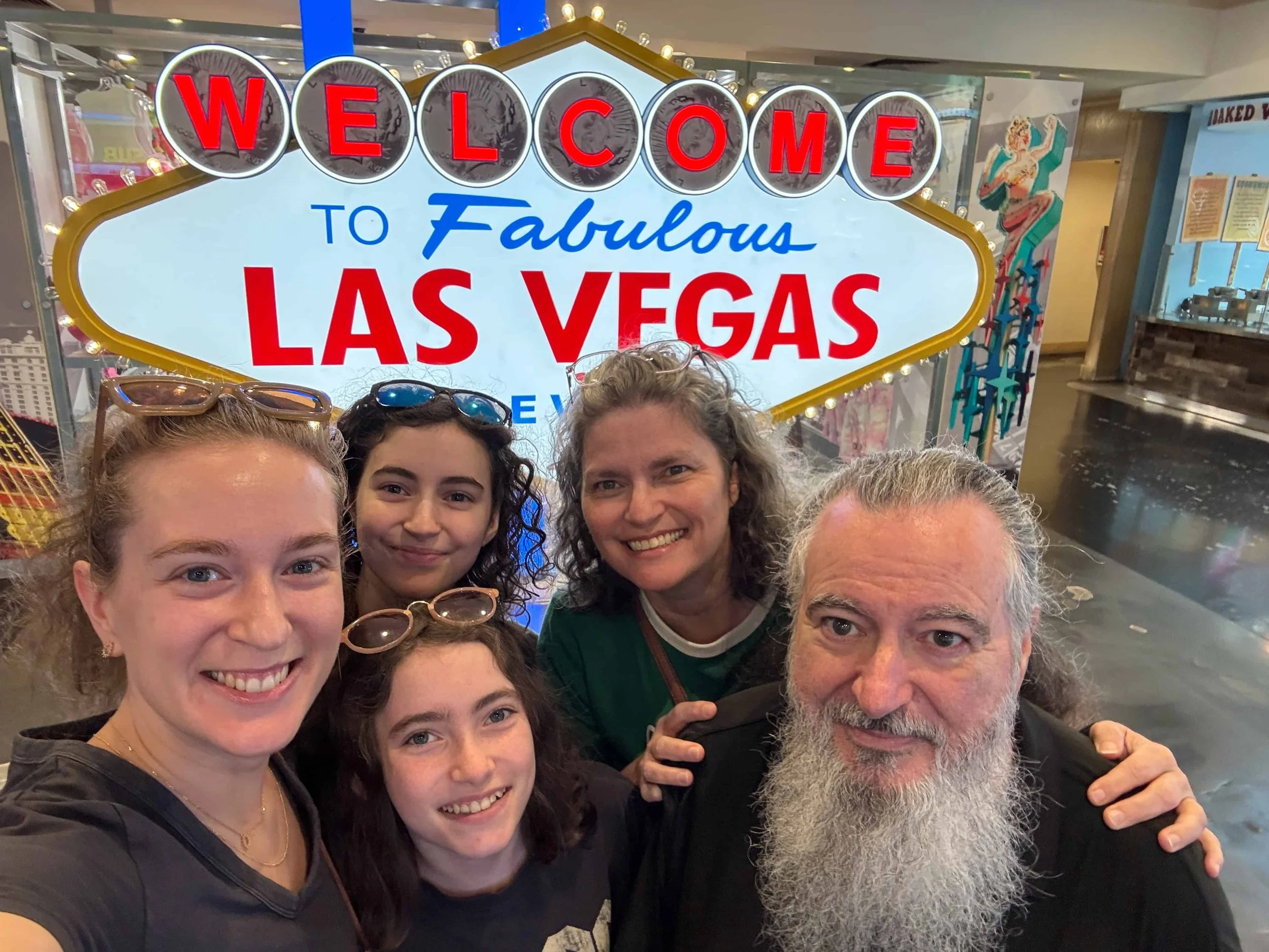 A fun, family selfie in front of a smaller version of the “Welcome to Fabulous Las Vegas” sign, located in the lower level of the Horseshoe Hotel & Casino.