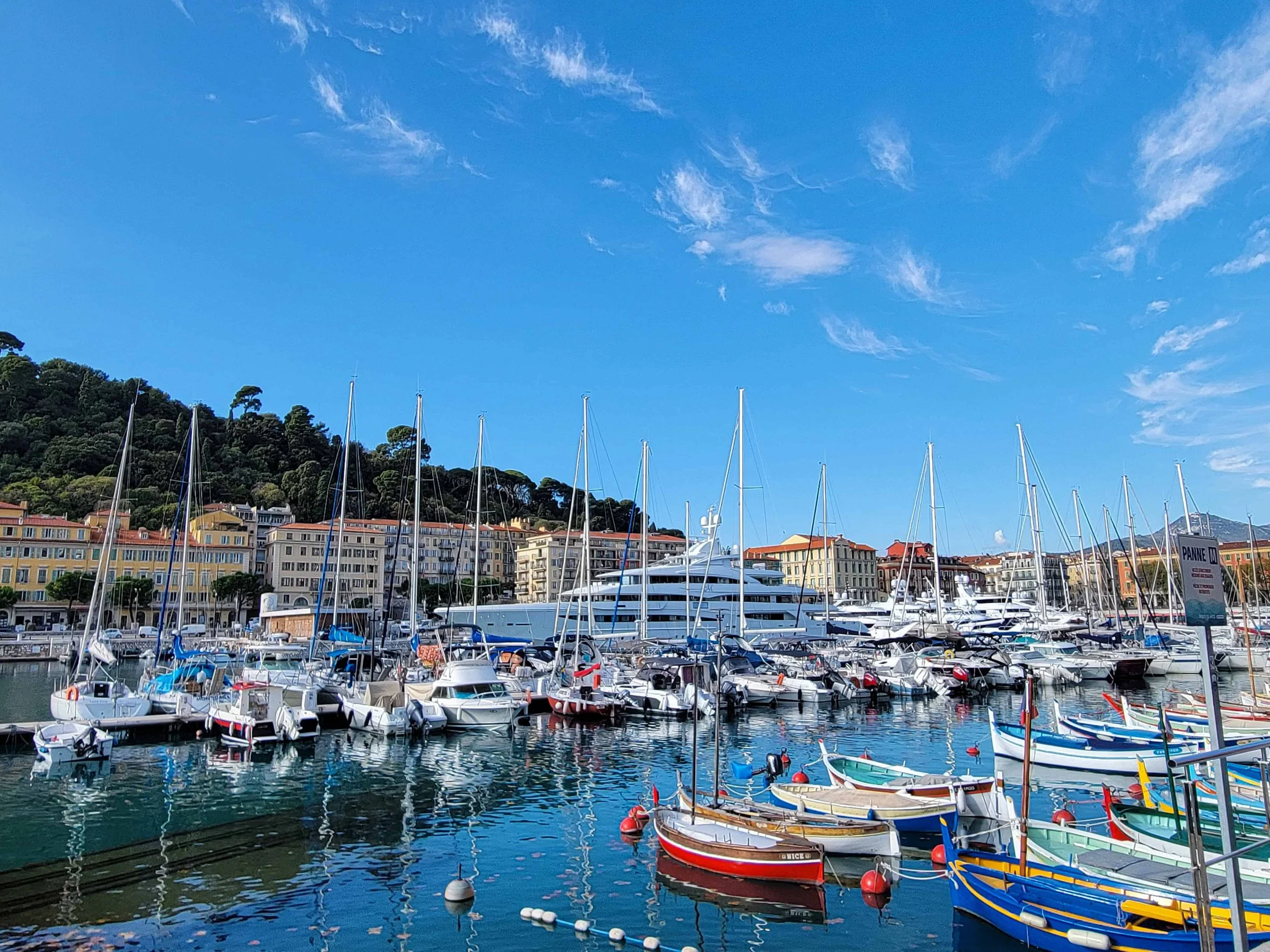 Colorful boats and superyacht at Port Lympia Nice France Old Port on a sunny day