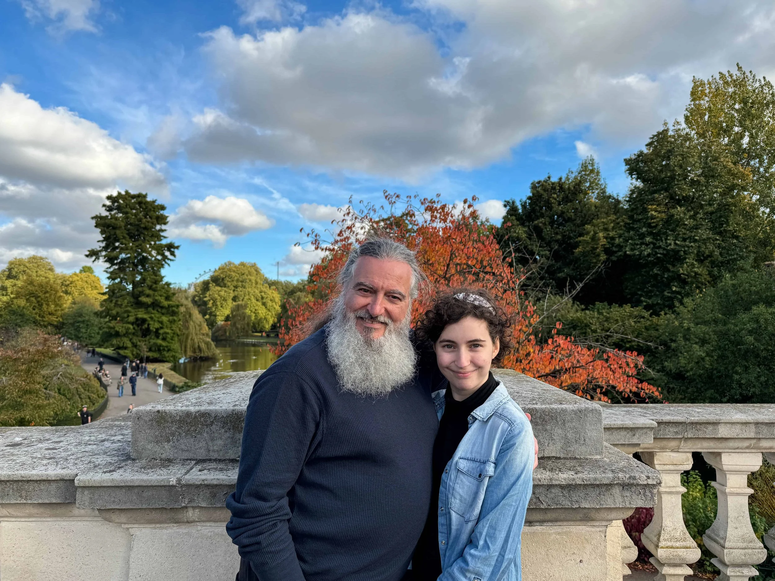 Family members Kevin and Rachel posing on a beautiful fall day near St James’s Park in London – budget-friendly park fun.