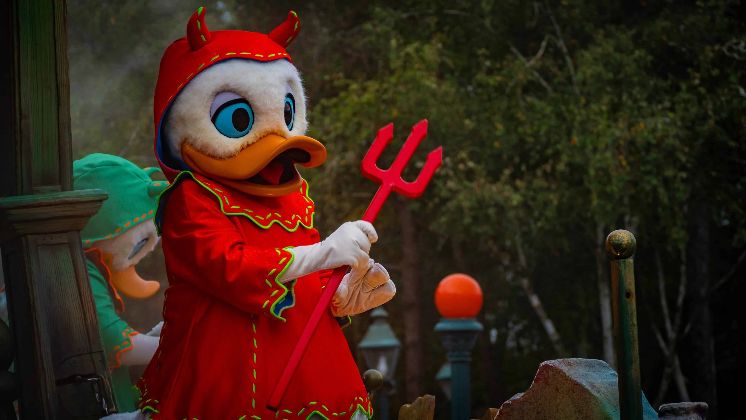 Donald Duck dressed in a red devil Halloween costume at Disneyland Paris.