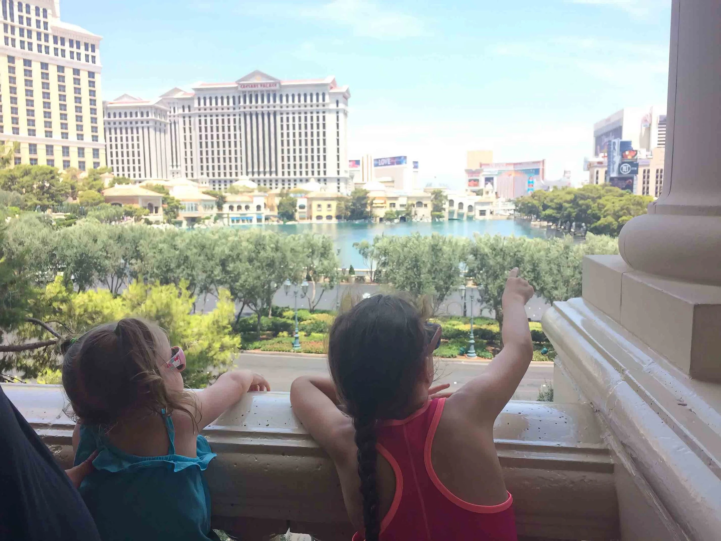Two kids taking in the view of the famous Las Vegas strip during a family vacation.