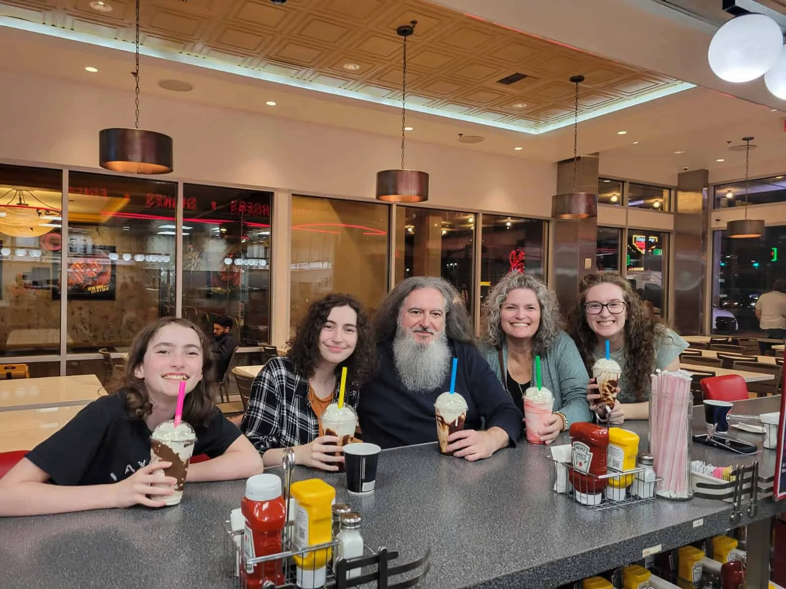 A family of 5 enjoying milkshakes at Johnny Rockets after the Blue Man Group show in Las Vegas