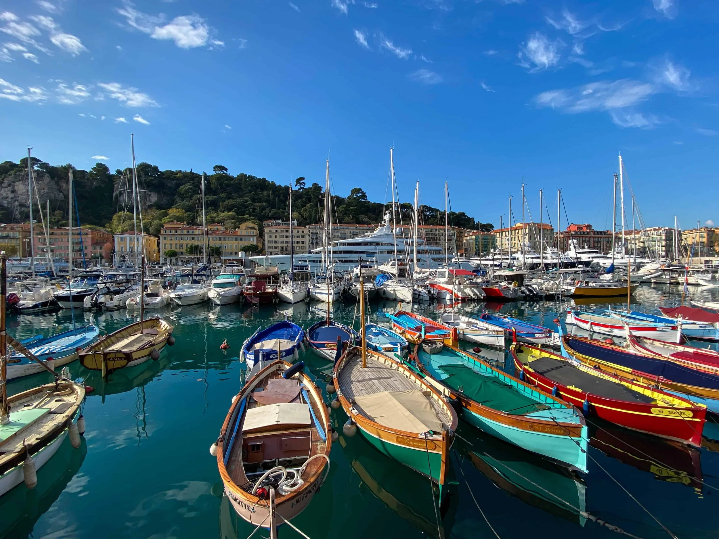 Colorful fishing boats and luxury yachts moored at Port Lympia Old Port of Nice France