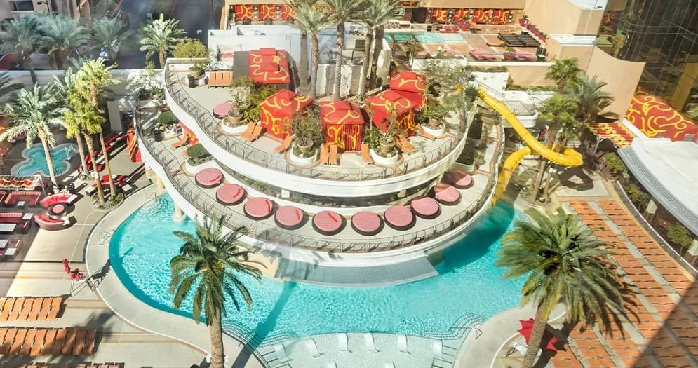 Aerial view of the Golden Nugget Tank pool in downtown Las Vegas, showing the yellow shark-tank slide and surrounding cabana deck.