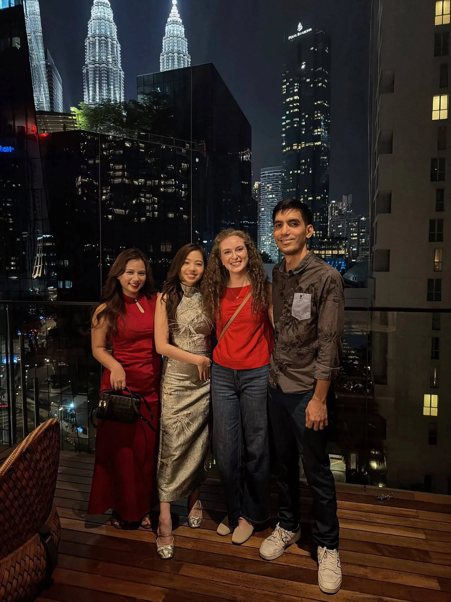 A young adult participating in Lunar New Year celebrations alongside friends from an expat community in Kuala Lumpur, Malaysia. They capture the joy of forming meaningful relationships through nomadic family life.