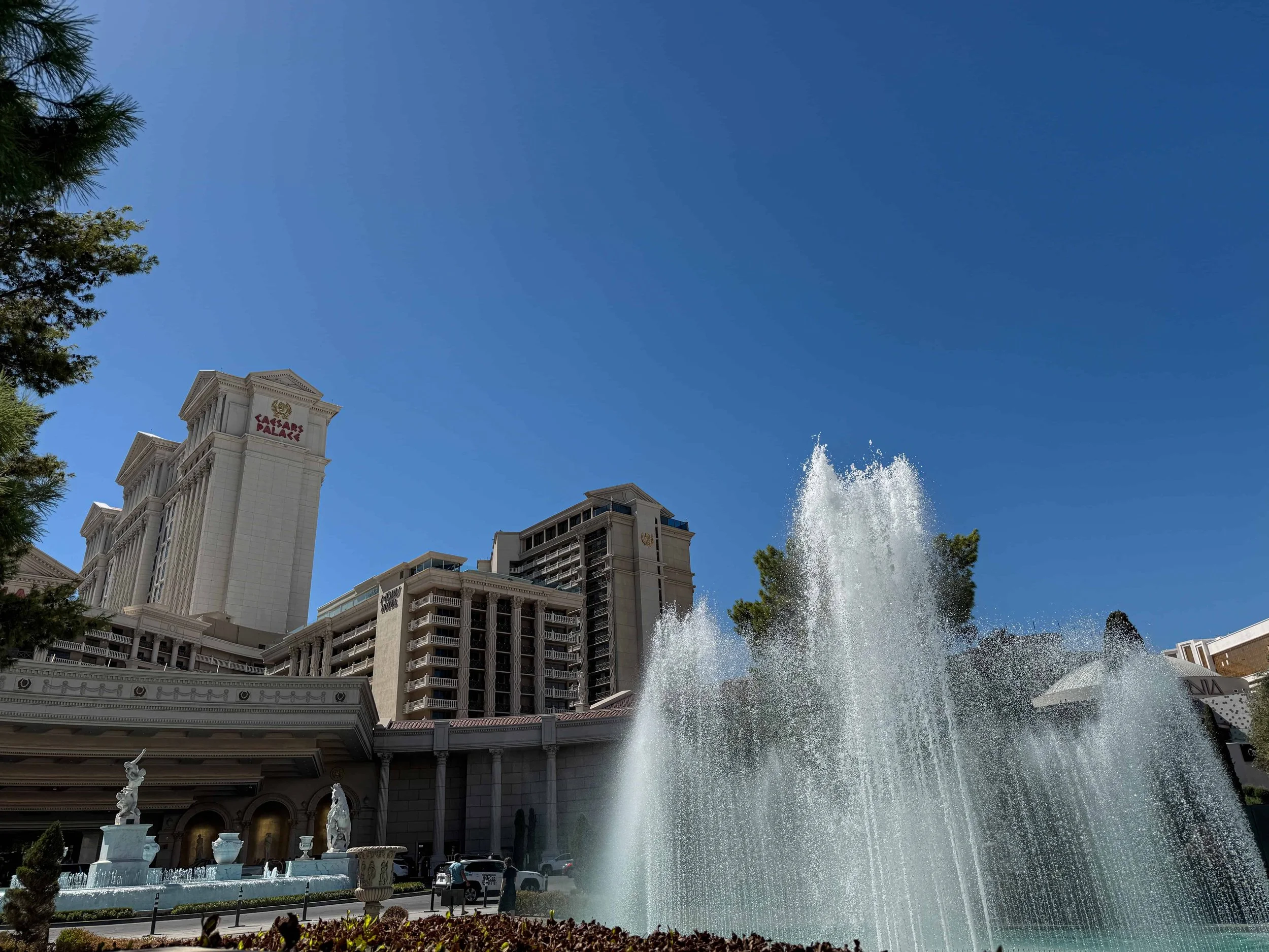 An exterior daytime view of the Las Vegas Caesars Palace and famous fountains.