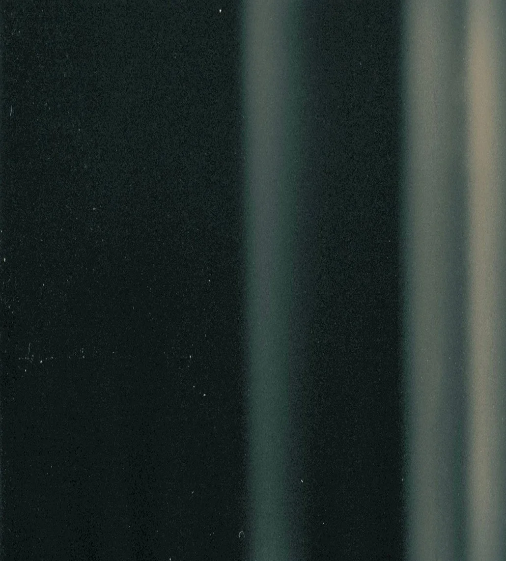 Close-up of a metallic surface with a vertical gradient of dark to light shades.