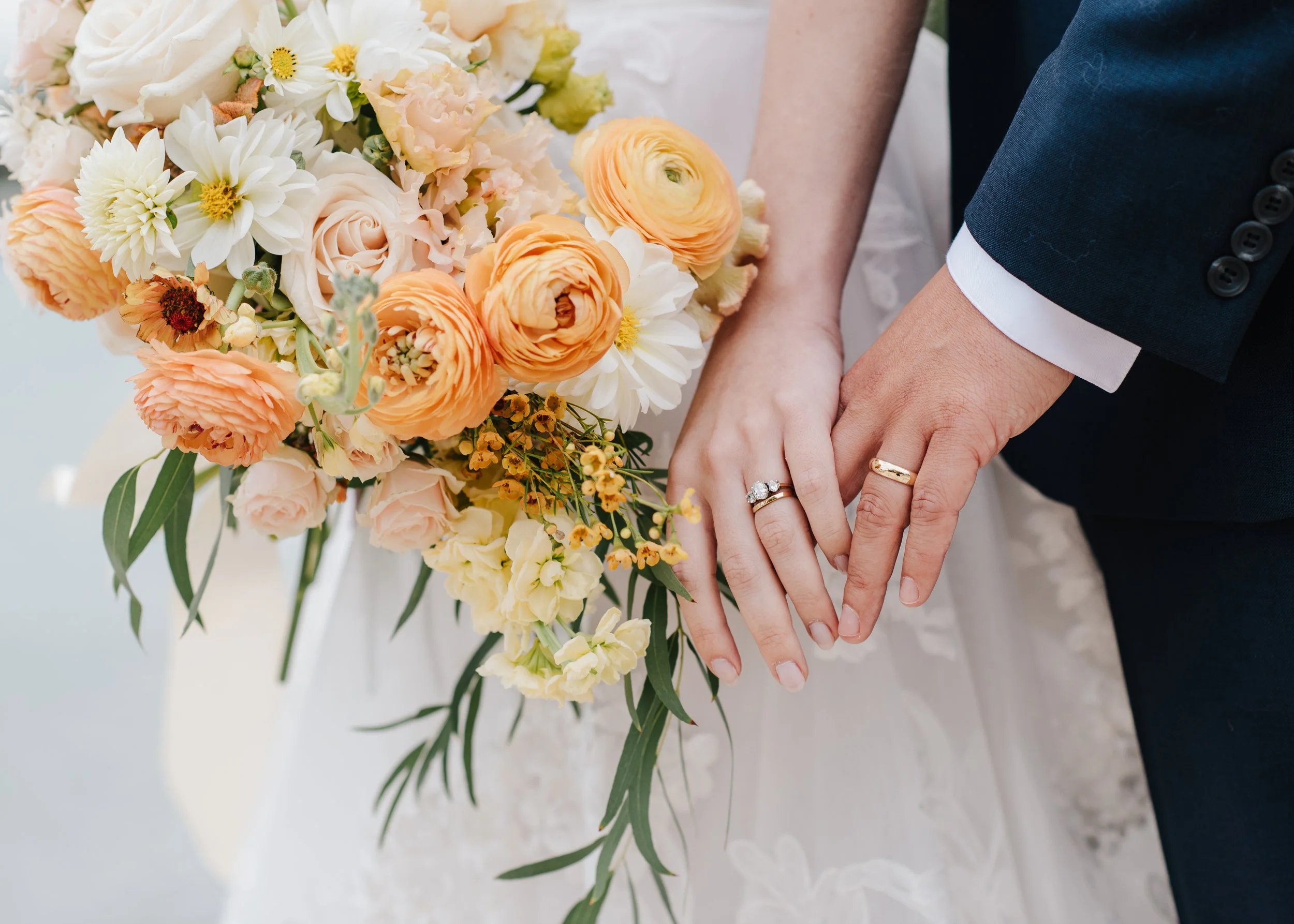bride hand holding grooms hand