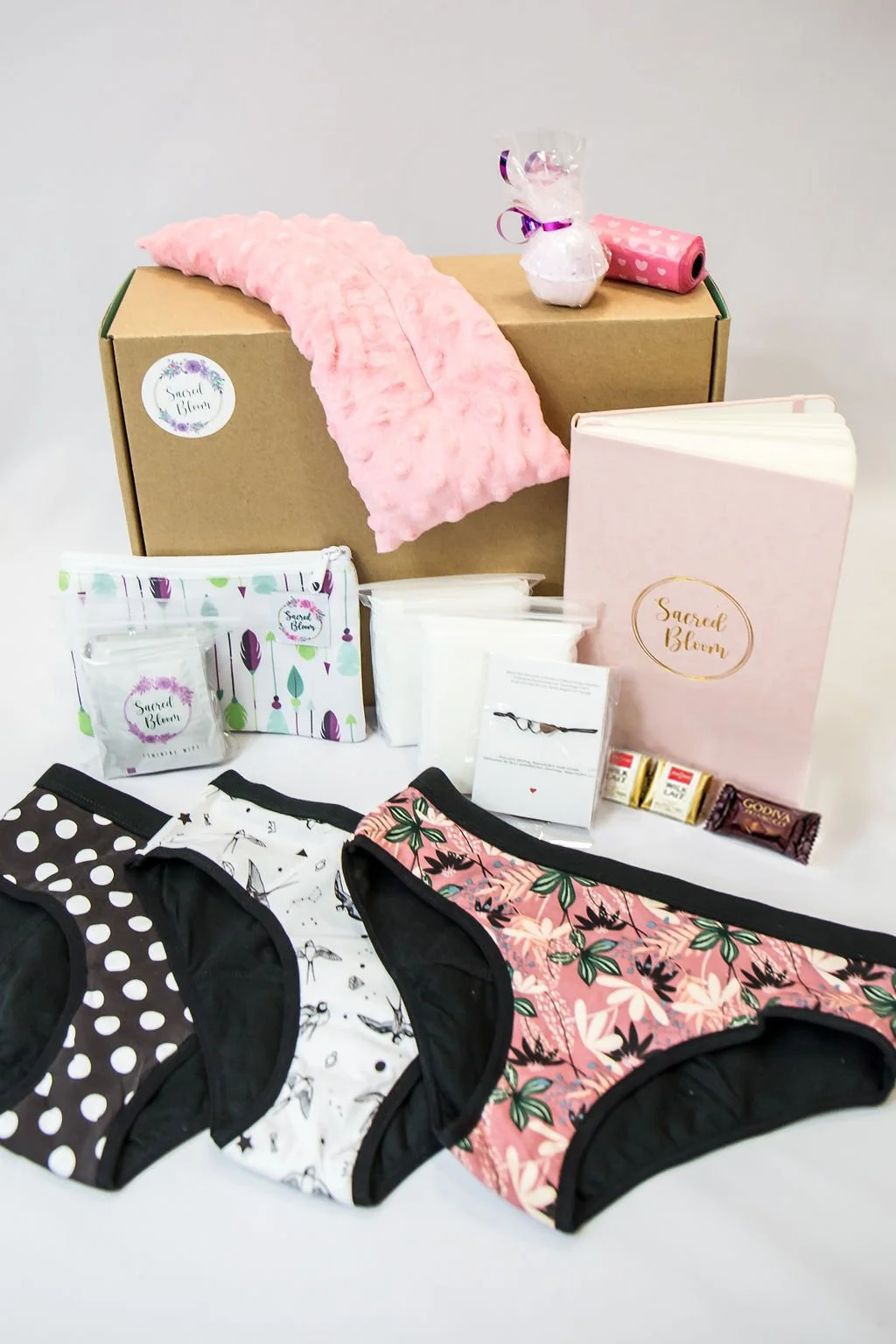 First Period Kit - Canadian Bloom Box with journal, period underwear, wet bag, feminine wipes, organic pads, bath bomb, and period education.