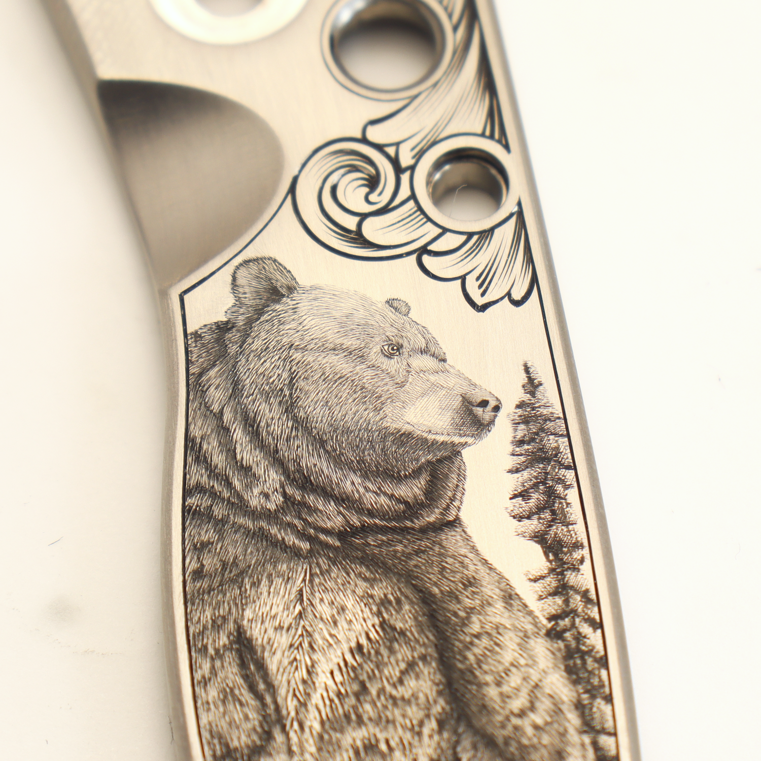 close up of an engraved bear etched onto a knife