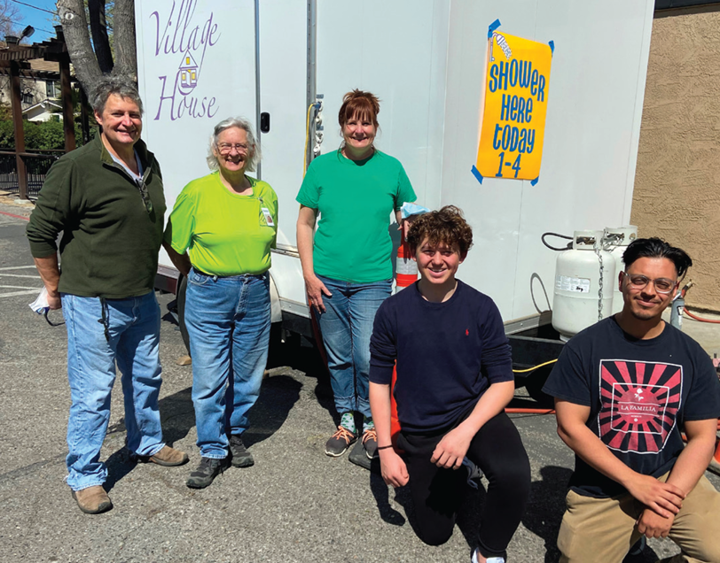 Volunteer Larry Cargnoni (top left) and volunteers  Accompaniment Volunteer Larry Cargnoni (top left), also volunteers with a mobile shower van, donated by The Village House, that is set up at Our Lady of Refuge each Thursday. Volunteers, including 