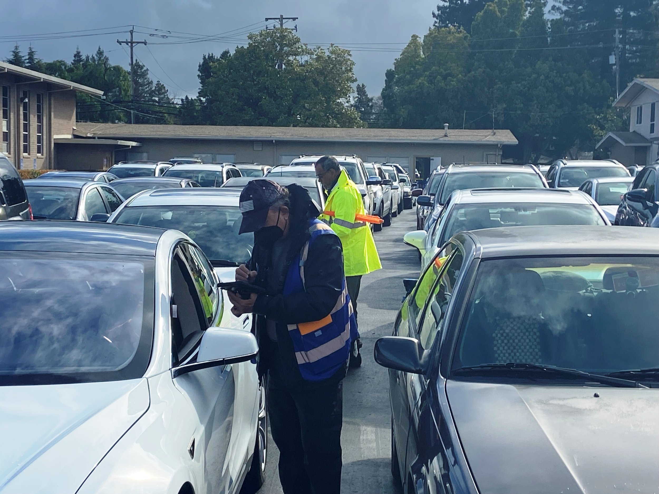   Cars line up for drive-through food distribution  