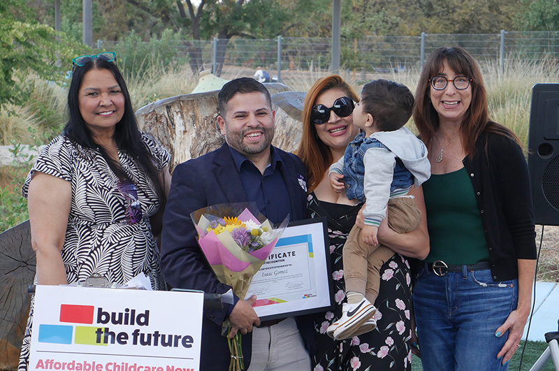 Isaac Gomes receives award from Supervisor Susan Elle