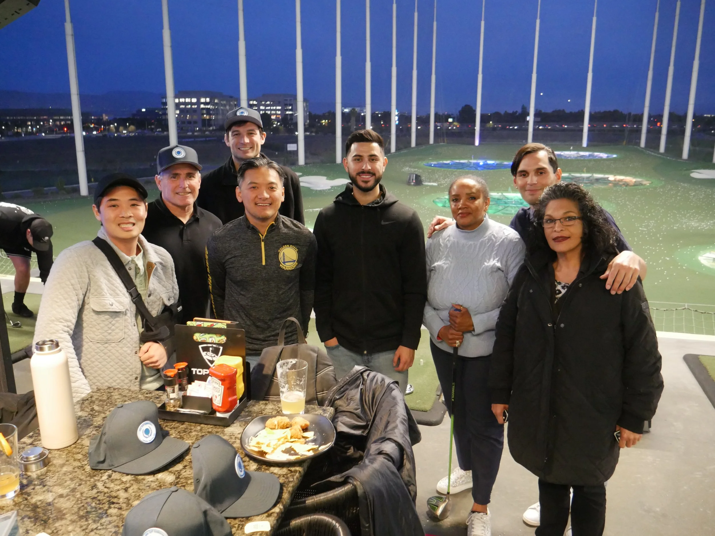 A group of attendees enjoying their food and beer at the event.