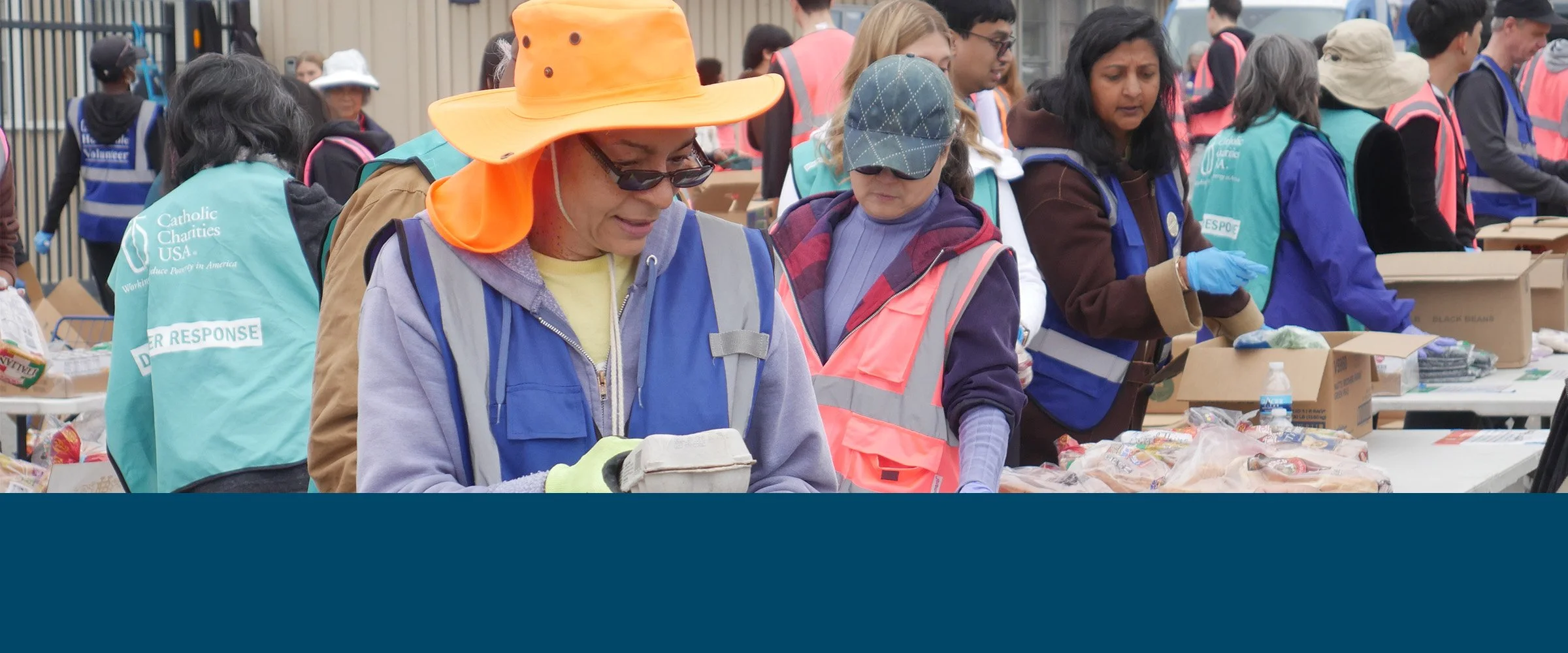 Group of volunteers with boxed groceries.