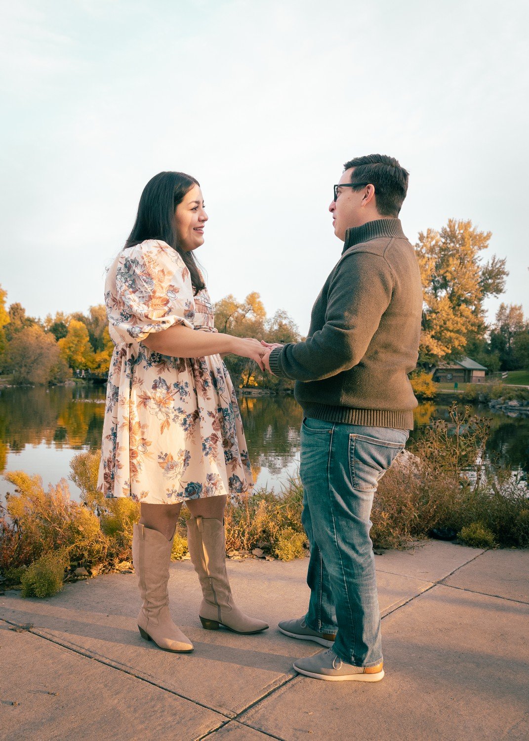 a couple that just got engaged standing by a lake.jpg