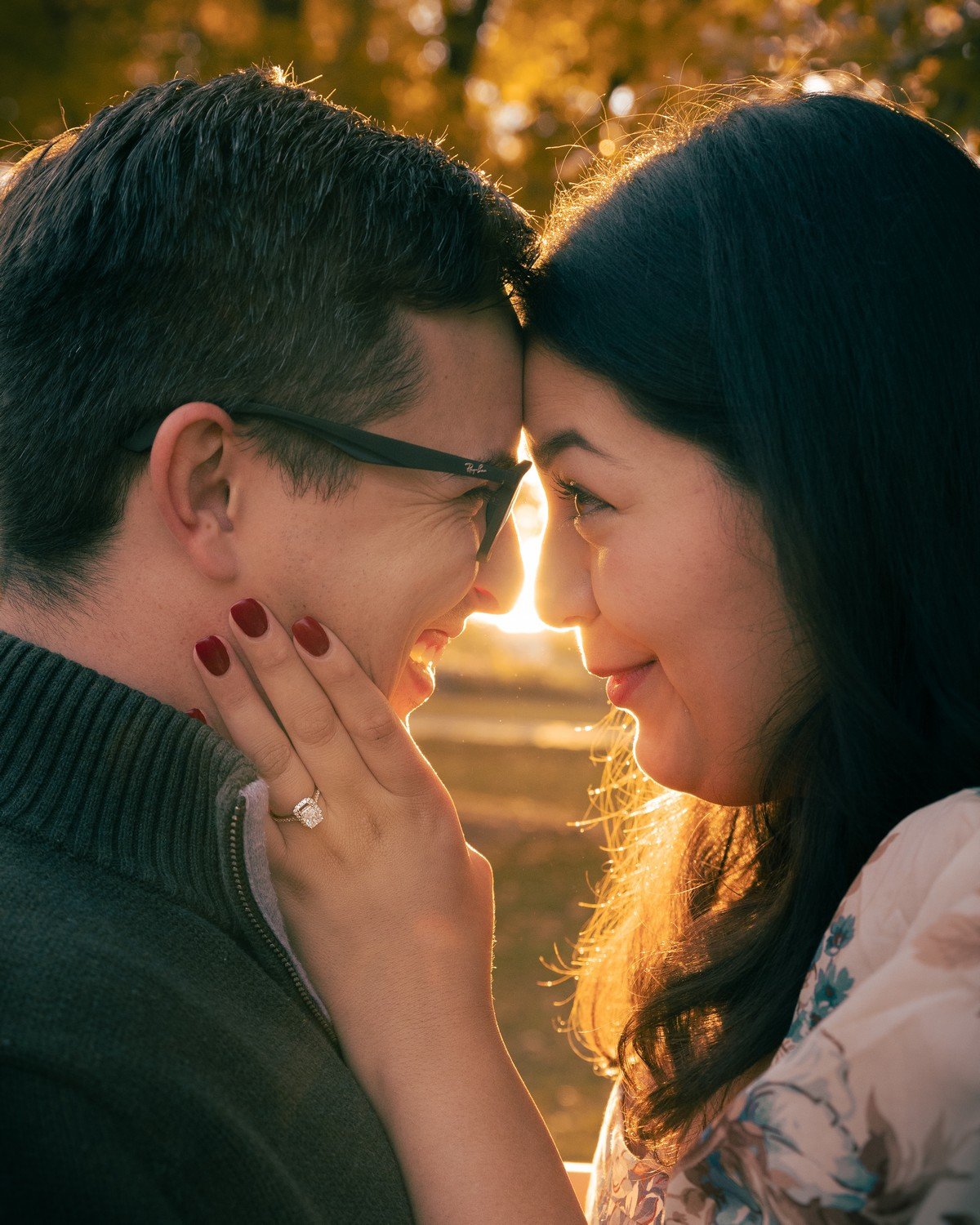 a newly engaged couple pressing their foreheads together.jpg