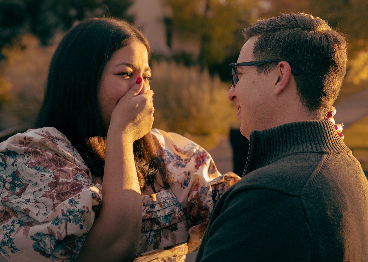 a woman covering her mouth in surprise when she gets propsed to.jpg