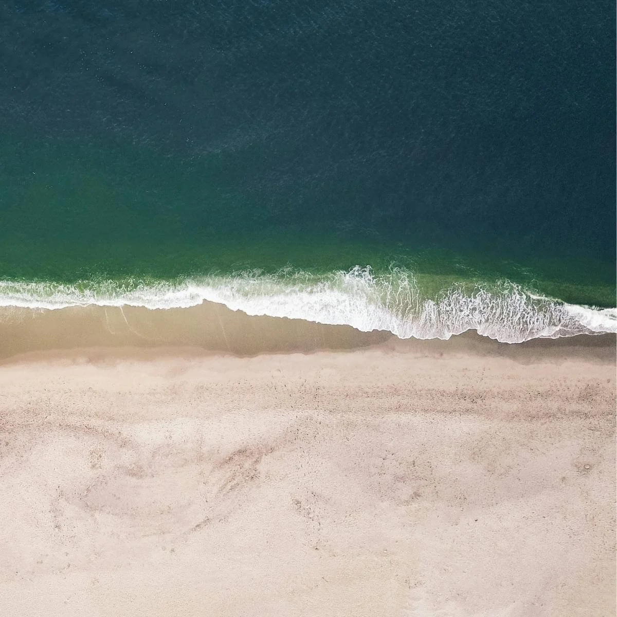 the sea shore from above, sand and waves